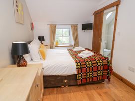 A bedroom with a bed and lamp at Greffyn in Betws-Y-Coed