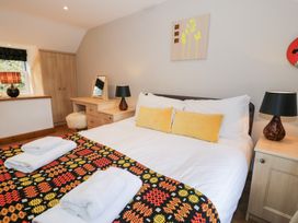 A bedroom with a bed and nightstand at Greffyn in Betws-Y-Coed