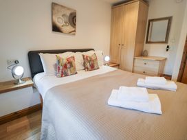 A bedroom with a bed and storage at Greffyn in Betws-Y-Coed