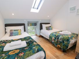A bedroom with two beds and a skylight at Greffyn in Betws-Y-Coed