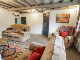 A living room with sofas and a coffee table at Orsedd Wen Farmhouse Betws-Y-Coed