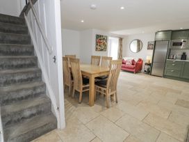 A dining room with a table and chairs at Orsedd Wen Farmhouse Betws-Y-Coed