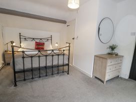 A bedroom with a bed and furniture at Orsedd Wen Farmhouse in Betws-Y-Coed