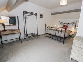 A bedroom with a bed and furniture at Orsedd Wen Farmhouse in Betws-Y-Coed