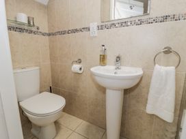 A bathroom featuring a toilet and sink at Orsedd Wen Farmhouse in Betws-Y-Coed
