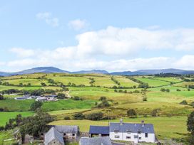 A landscape view with fields and houses at Orsedd Wen Farmhouse in Betws-Y-Coed