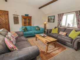 A living room with sofas and a coffee table at Orsedd Wen Cottage Betws-Y-Coed