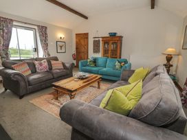 A living room with sofas and a coffee table at Orsedd Wen Cottage in Betws-Y-Coed