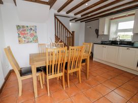 A dining room with a table and chairs at Orsedd Wen Cottage in Betws-Y-Coed