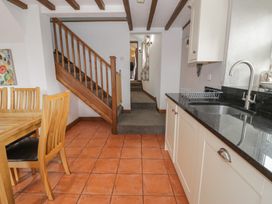 A kitchen with a dining table and chairs at Orsedd Wen Cottage in Betws-Y-Coed