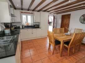 A kitchen with a table and chairs at Orsedd Wen Cottage Betws-Y-Coed