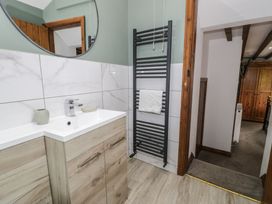 A bathroom with a washbasin and towel rail at Orsedd Wen Cottage in Betws-Y-Coed