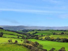 A landscape view of fields and hills at Orsedd Wen Cottage Betws-Y-Coed
