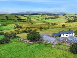 A farmhouse and outbuildings in a rural landscape at Orsedd Wen Cottage Betws-Y-Coed