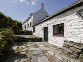 An outdoor view of a stone pathway leading to a house at Cwm, Capel Curig