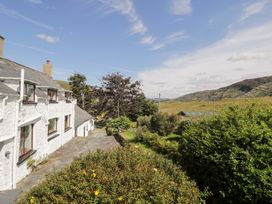 A house with a garden and hills in the background at Cwm, Capel Curig