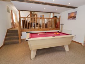 A game room with a pool table and stairs at Cwm in Capel Curig