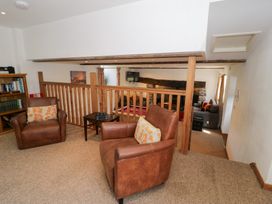 A living room with armchairs and a coffee table at Cwm in Capel Curig