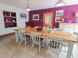 A dining room with a table and chairs at Cwm in Capel Curig