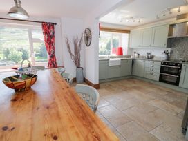 A kitchen with wooden table and chairs at Cwm in Capel Curig