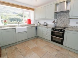A kitchen with a sink and stove at Cwm in Capel Curig