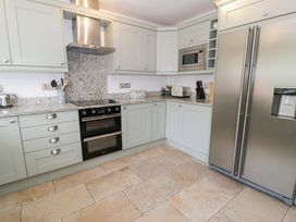 A kitchen with a fridge, oven and microwave at Cwm in Capel Curig