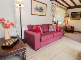 A sitting room with a sofa and armchair at Cwm in Capel Curig