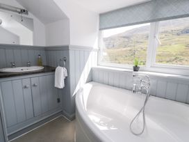 A bathroom with a bathtub and sink at Cwm in Capel Curig