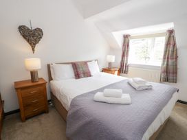 A bedroom with a bed and nightstands at Cwm in Capel Curig