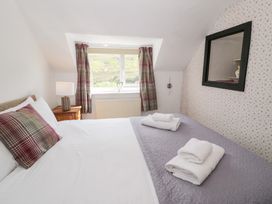 A bedroom with a bed and a window at Cwm in Capel Curig