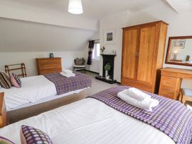 A bedroom with two beds and furniture at Cwm in Capel Curig
