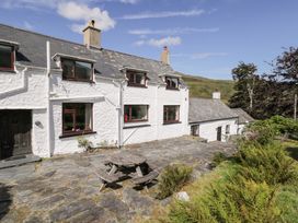 A house with a patio and table at Cwm in Capel Curig