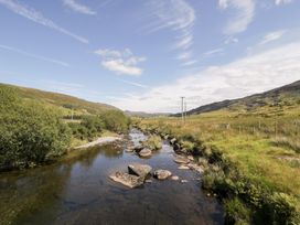 A river with rocks and grass at Cwm in Capel Curig