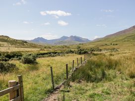 A landscape with mountains and a fence at Cwm in Capel Curig