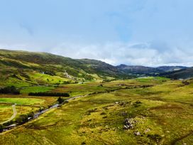 A view of hills and a river in a landscape at Cwm Capel Curig