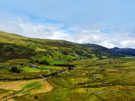 A landscape with mountains and a river at Cwm in Capel Curig