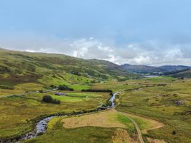 A landscape with a river and fields at Cwm in Capel Curig