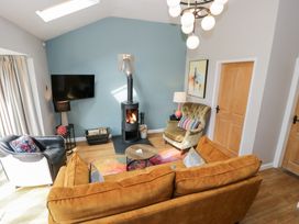 A living room with a sofa and fireplace at Pengwern Bach Llanrwst