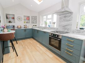 A kitchen with cabinets and appliances at Pengwern Bach in Llanrwst
