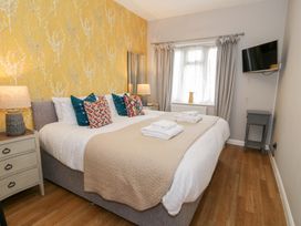 A bedroom with a bed and television at Pengwern Bach in Llanrwst