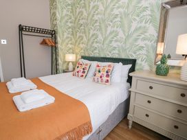 A bedroom with a bed and dresser at Pengwern Bach in Llanrwst