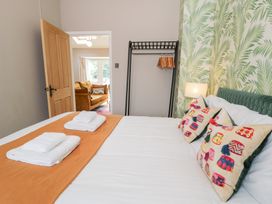 A bedroom with a bed and wardrobe at Pengwern Bach in Llanrwst