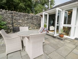 An outdoor patio with a table and chairs at Pengwern Bach in Llanrwst