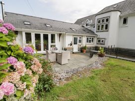 An outdoor patio area with chairs and a table at Pengwern Bach Llanrwst