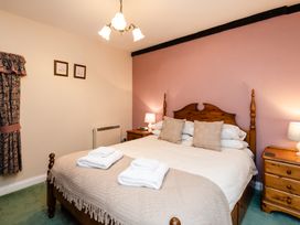 A bedroom with a double bed and nightstands at Lupin Cottage Akeld near Wooler
