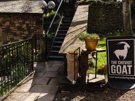 An outdoor area with a sign and stairs at The Cheviot Goat Akeld near Wooler