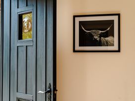 An entrance with a door and a framed picture at Bramble Cottage in Akeld near Wooler