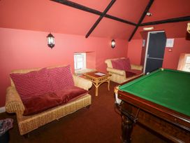 A snug with a pool table and seating at Tile Rouge in Wooler