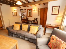 A living room with a sofa and a table at Two Town End in Mungrisdale, Mosedale