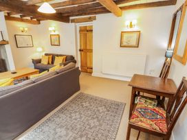A living room with a sofa and coffee table at Two Town End in Mungrisdale, Mosedale